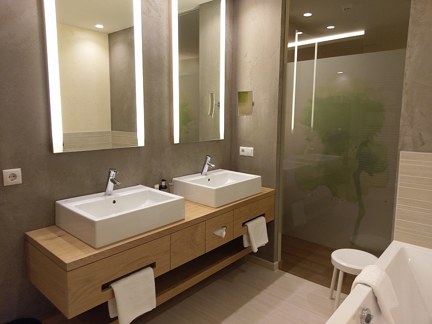 Feldhof DolceVita Resort: Im Bad freuen wir uns über Doppelwaschbecken, eine Badewanne und die großzügig gestaltete Luxusdusche.